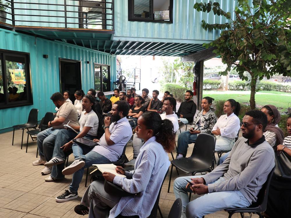 Participants seated at an outdoor masterclass