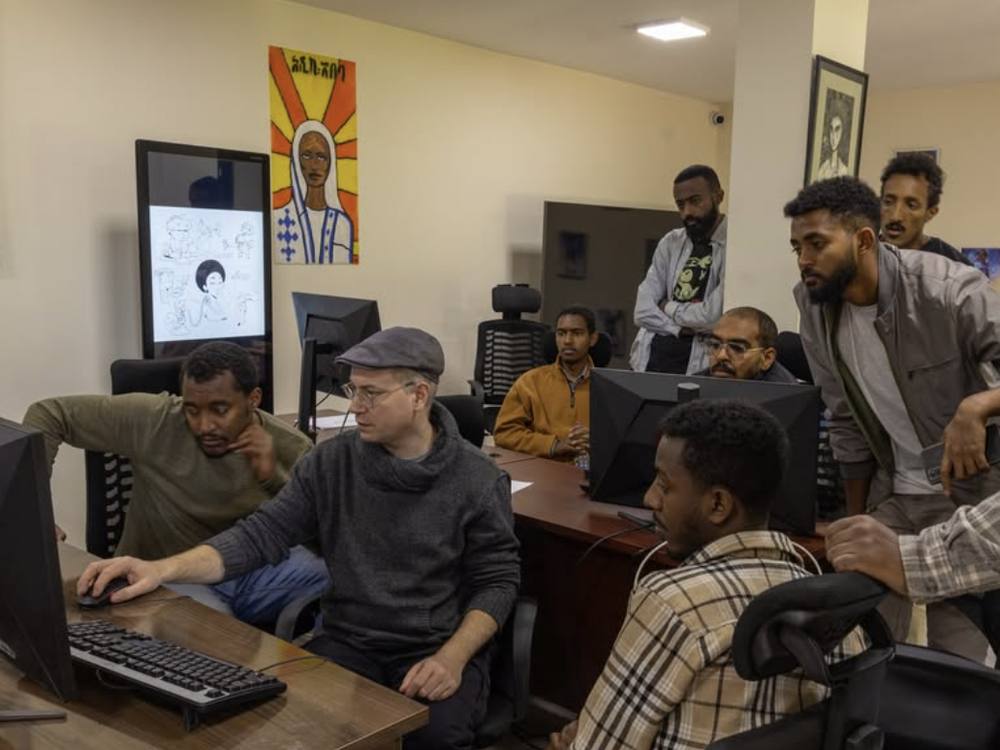 Creatives working together at computer workstations